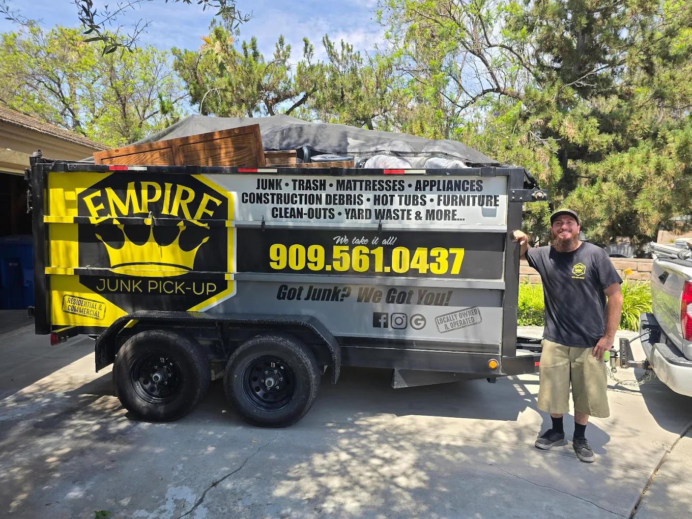 Adam, owner of Empire Junk Pick Up, with the company dump trailer