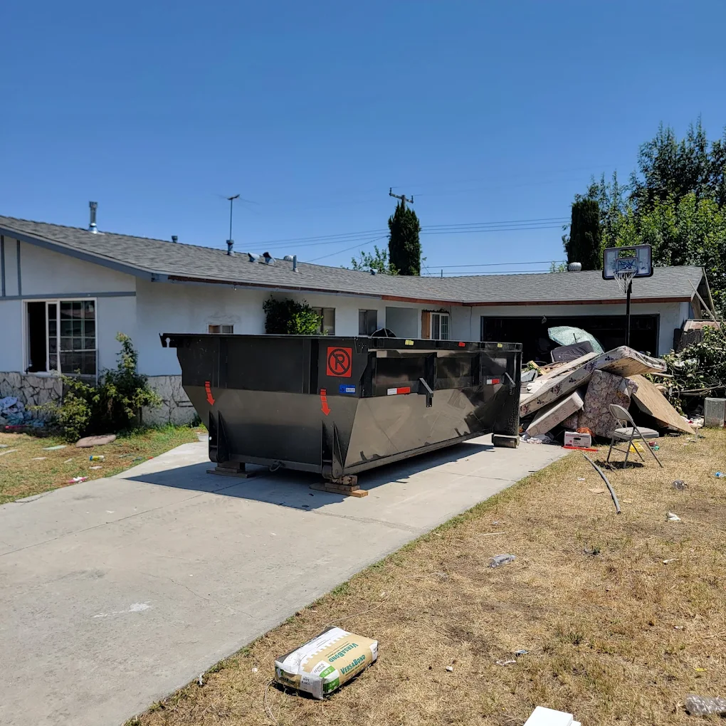 Empire Junk dumpster on driveway